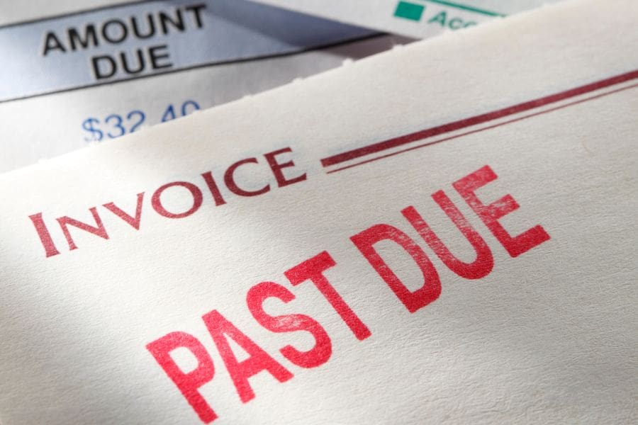 A random selection of bills and statements with one of them stamped "past due".