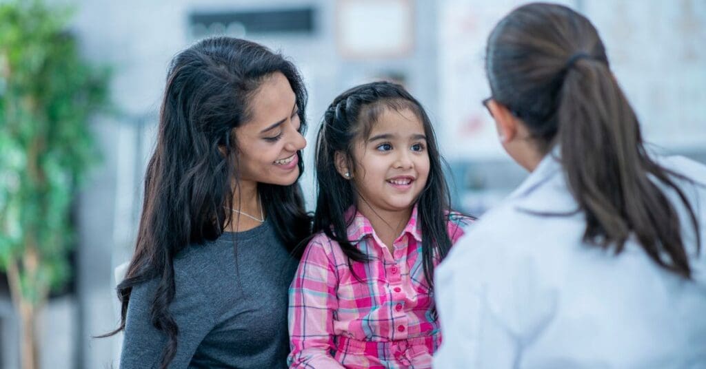 After completing the Ontario health card application requirements, a newcomer mother and daughter visit a family doctor.