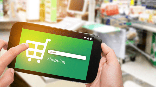 A shopper is comparing shopping prices on their mobile phone to look for cost saving ideas