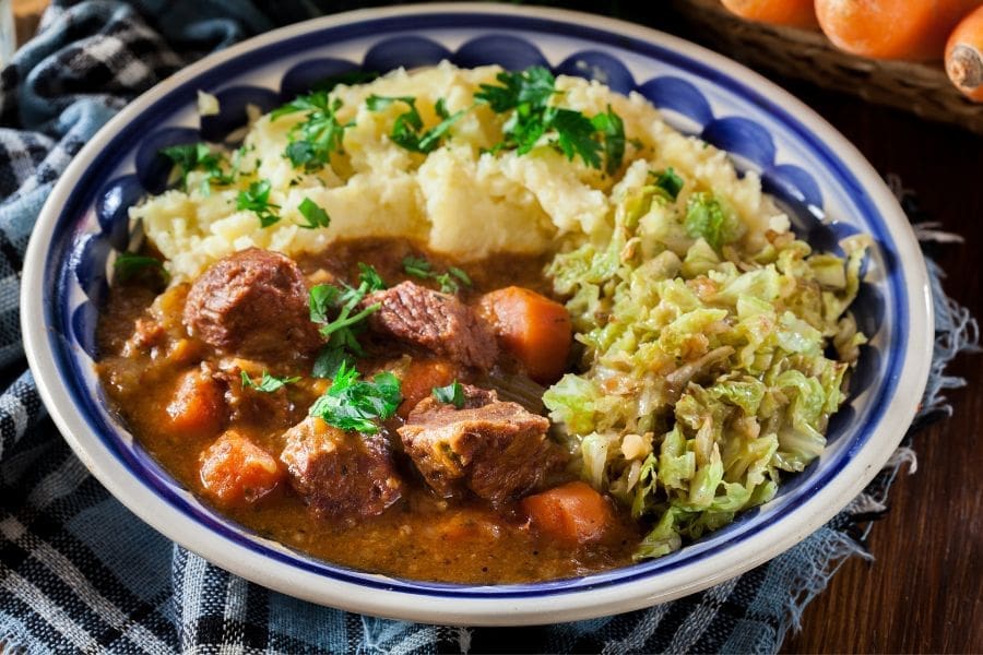 Traditional Irish stew served with mashed potatoes and cabbage on St. Patrick's Day.