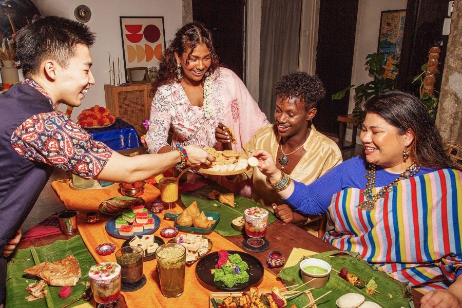 Friends are sharing a Diwali feast. 
