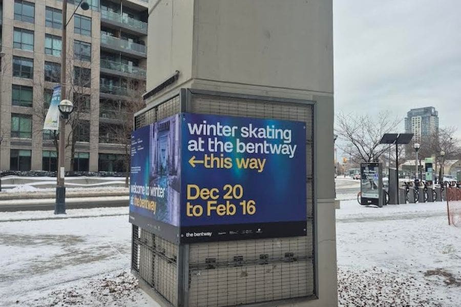 A sign reads "winter skating at the bentway" a popular outdoor skating rink in Toronto, Ontario.