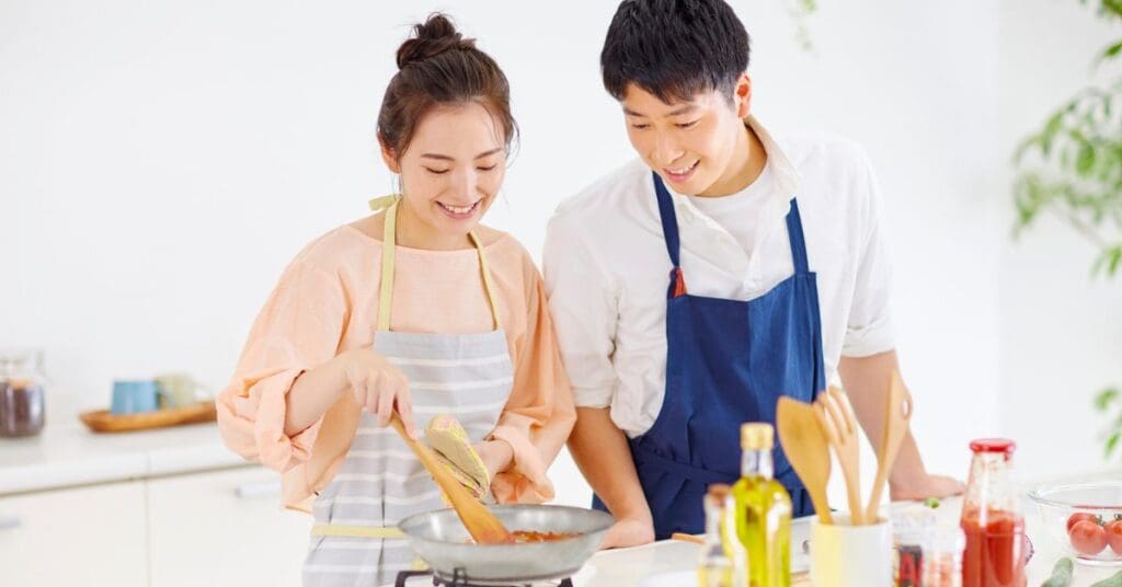 A young couple are cooking a romantic Valentine's Day dinner at home dinner at home.