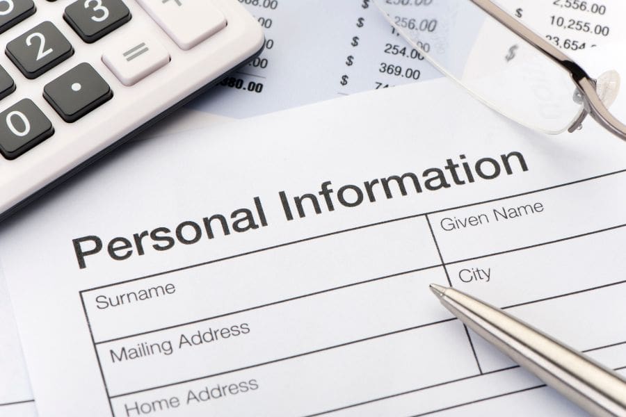 Close-up of a document asking for personal information and details, representing identity theft and financial fraud in Canada. 