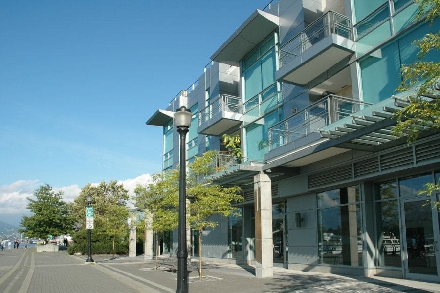 Low-rise apartment building near the Vancouver waterfront on a clear day, showing residential housing options close to parks, transit, and urban amenities.