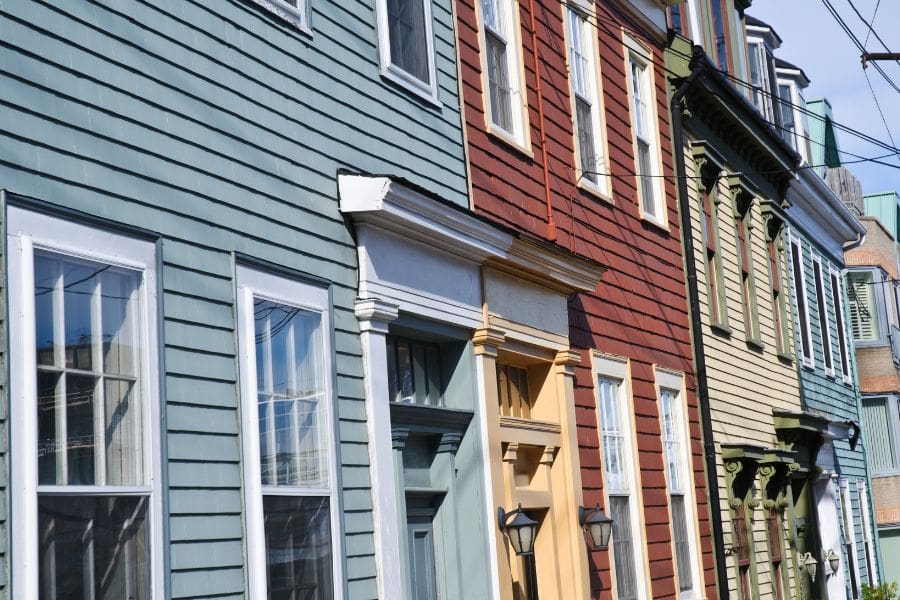 A residential neighbourhood with brightly painted, traditional heritage houses with unique architectural details.