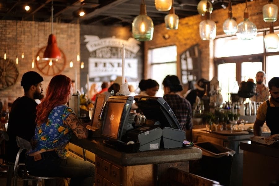 People are sitting in a trendy cafe.