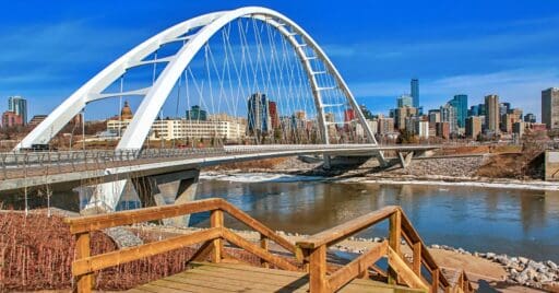 A panoramic view of the Walterdale Bridge and downtown Edmonton by the river valley.