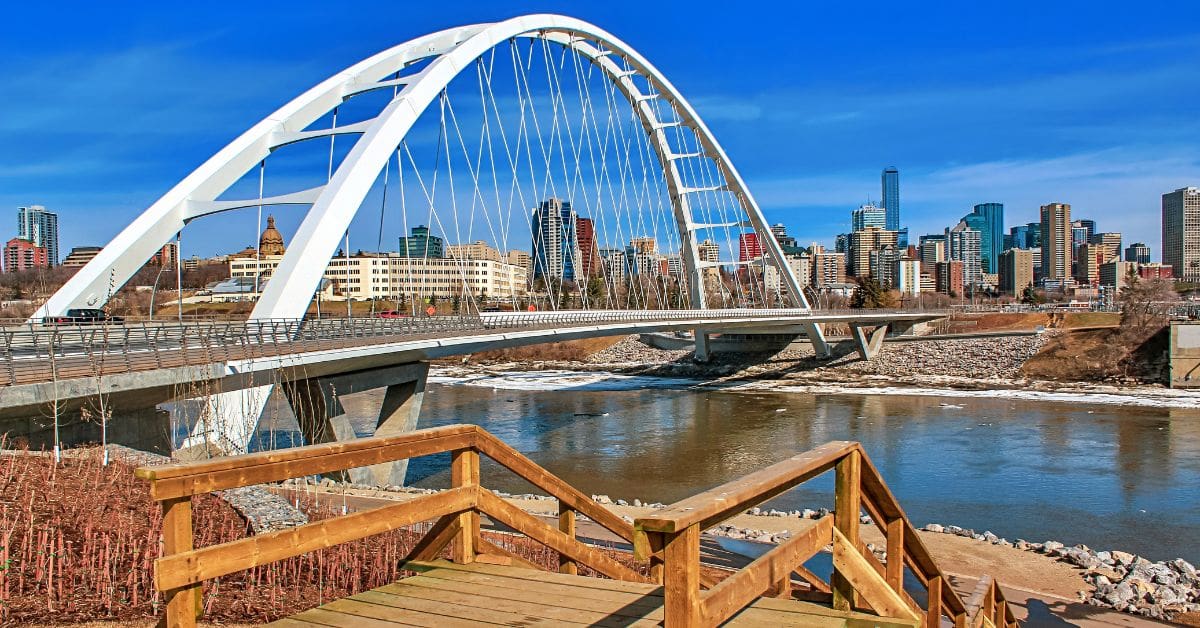 A panoramic view of the Walterdale Bridge and downtown Edmonton by the river valley.