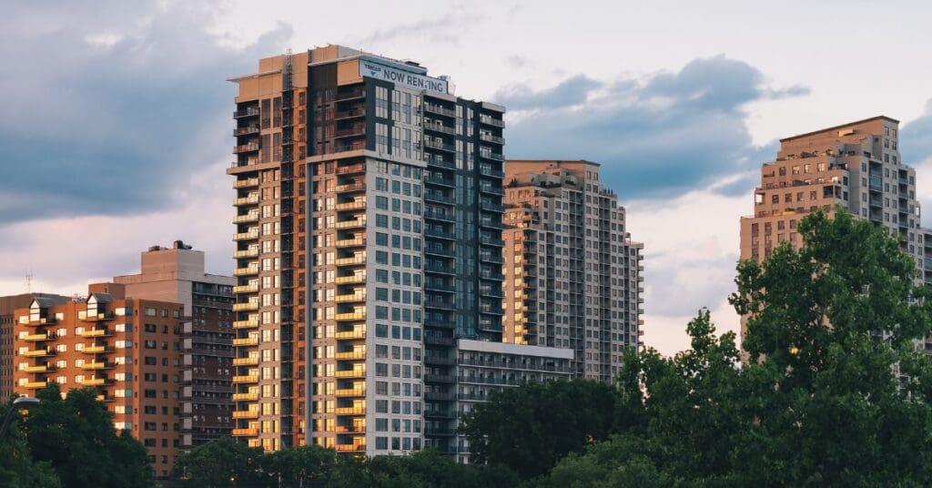 Modern apartment buildings among trees at sunset. Renting without a credit history in Canada is possible, but you have to prepare.