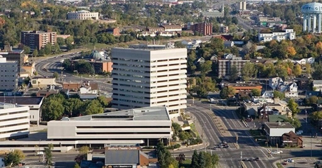 An aerial photograph of the downtown neighbourhood in Sudbury, Ontario on a summer day.