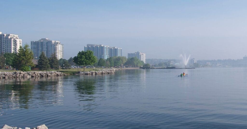 Barrie waterfront on a sunny day with condominiums in the background.