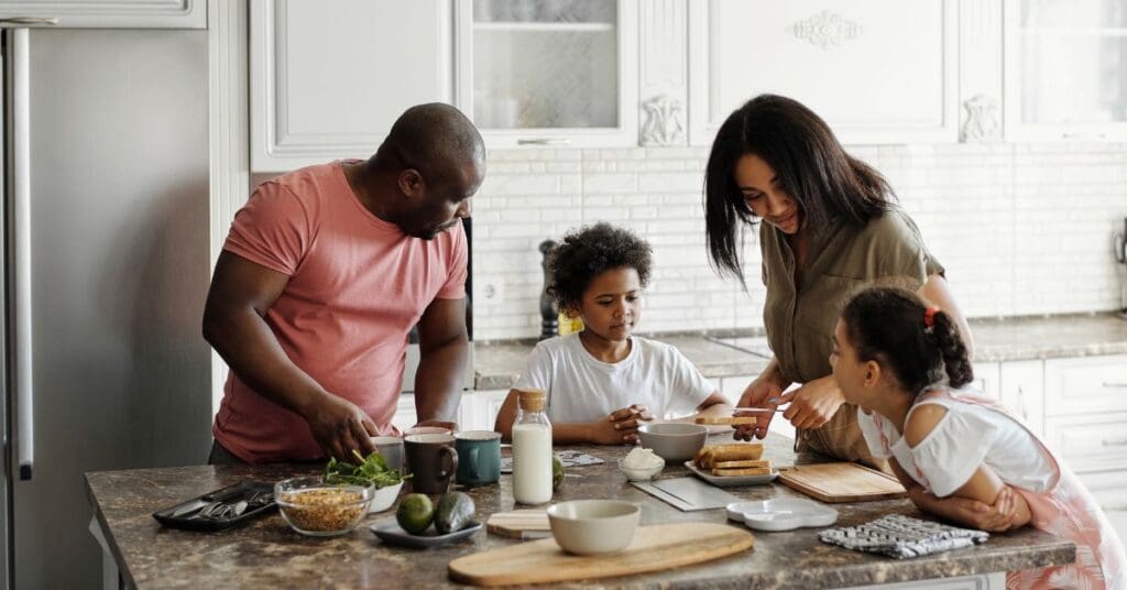 A young newcomer family is cooking dinner together to manage the cost of living in Canada.