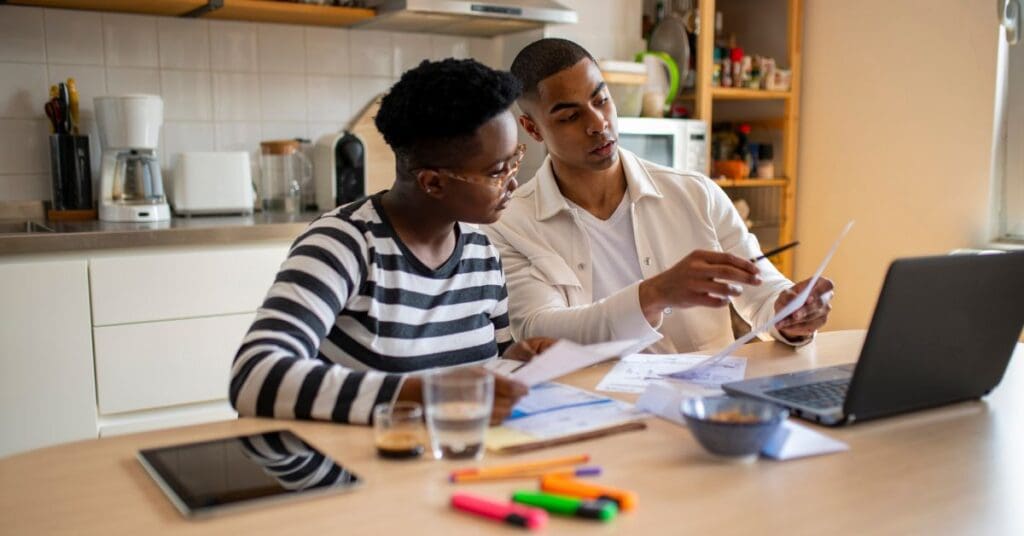 A young couple are discussing their finances during financial literacy month in Canada.