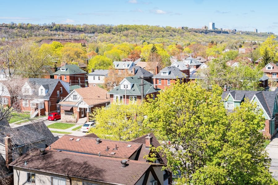 Aerial view of homes in Hamilton, Ontario, Canada - a reminder that smart investing and savings plans can help newcomers reach homeownership goals.  