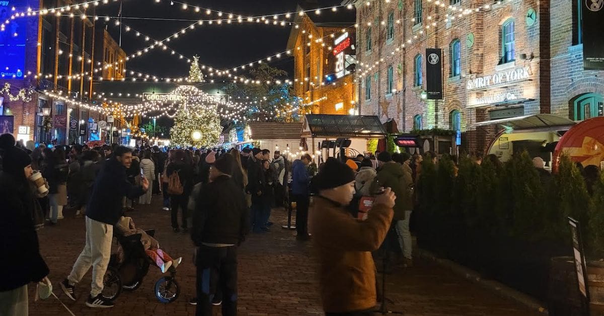 Crowds enjoying the festive lights at Toronto’s Distillery Winter Village, one of Canada’s most popular Christmas markets.