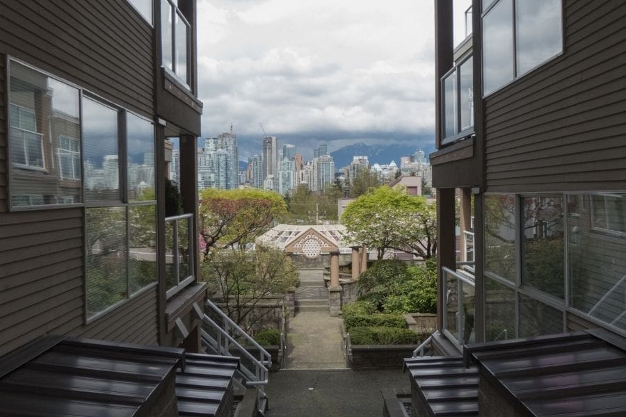 Residential apartment buildings in Mount Pleasant looking toward downtown towers, showing a best place to live in Vancouver BC Canada for newcomers.
