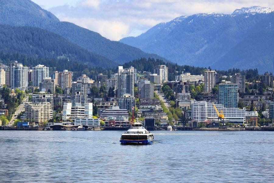 SeaBus ferry crossing Burrard Inlet toward Lonsdale Quay and the North Shore mountains in the background.