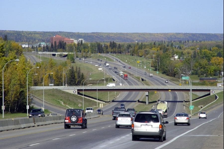 Cars and trucks driving on Highway 63 between, a key transportation route in Alberta. 
