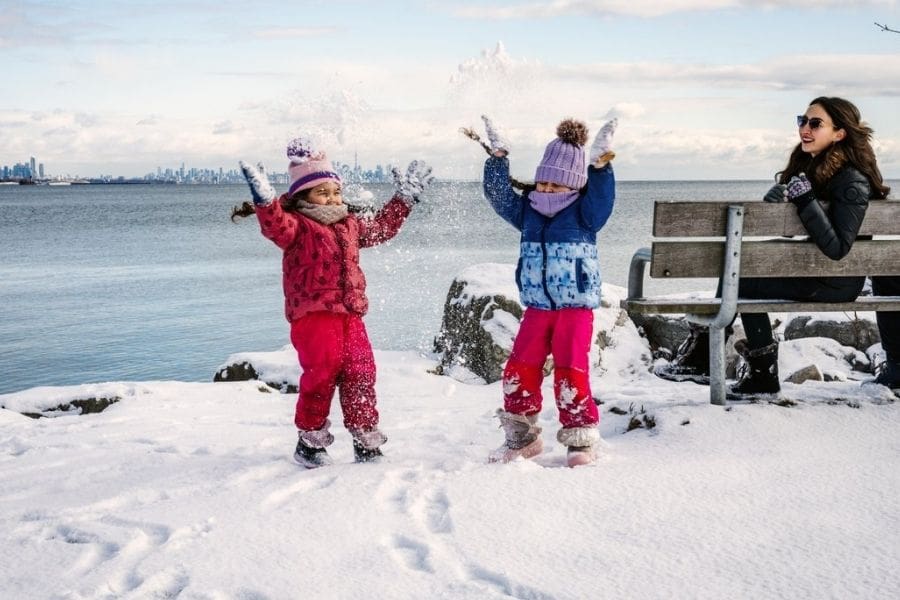 A family dressed in winter clothing on a cold winter day in Canada.