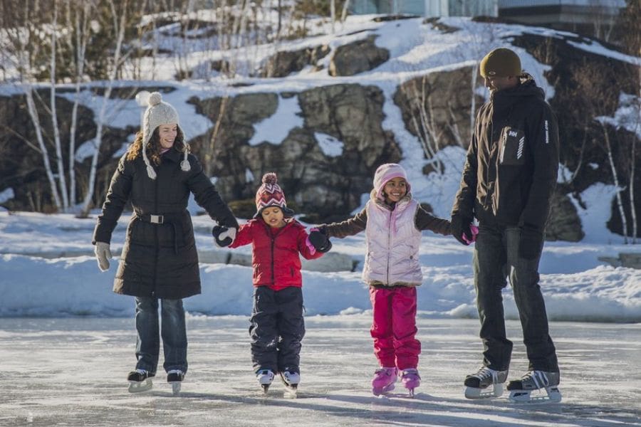 A family is skating outdoors during Family Day, a provincial statutory holiday in Canada