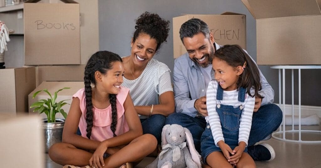 Newcomer family sitting in a rental apartment in Canada