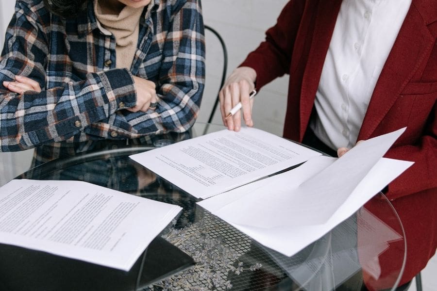 A landlord is reviewing a prospective tenant's rental application documents.