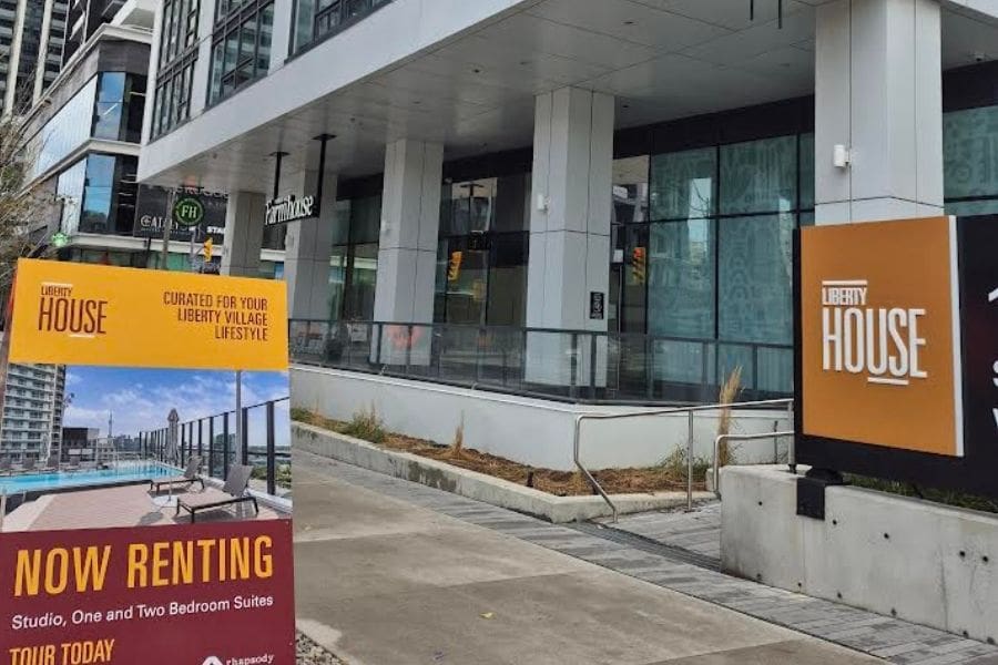 A modern apartment building in the Toronto rental market displaying a "Now Renting" sign with luxury amenities, highlighting the 2026 surge of new supply and newcomer incentives in the Canada rental market.