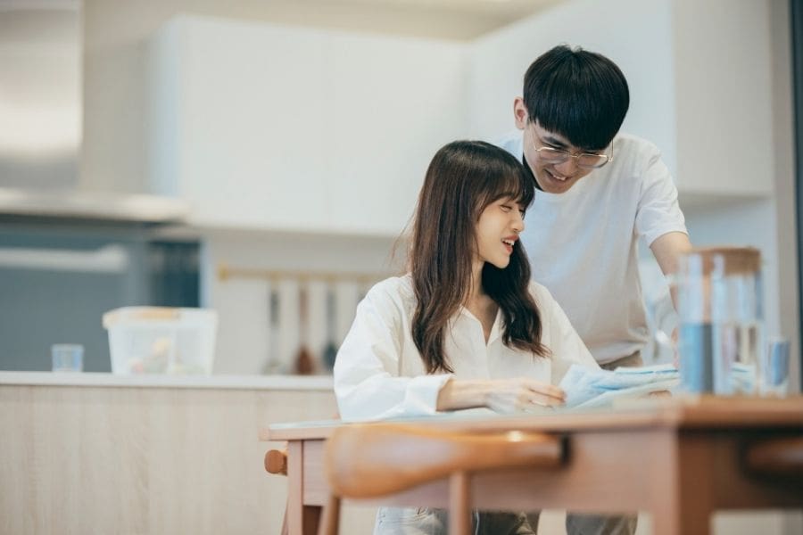 A young Asian couple are planning their budget together and setting a Valentine's Day budget