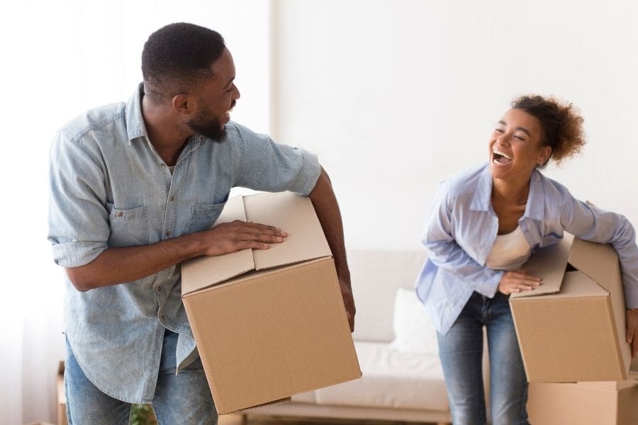 A happy newcomer couple in their short-term rental in Canada. The image highlights their success finding a short-term rental during the the 2026 World cup.