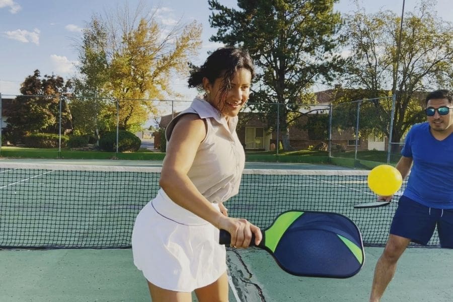 Newcomers playing pickleball at public municipal park in Canada.