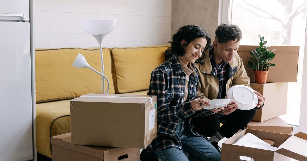 A newcomer couple in the process of packing their belongings and organizing a goods to follow list Canada for their move.