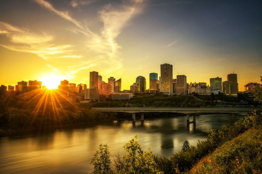 A golden sunset over the North Saskatchewan River and downtown skyline, capturing the beautiful Edmonton  summer evenings.