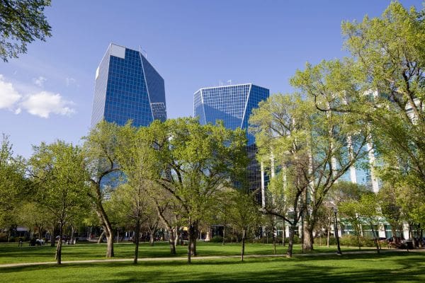 The modern McCallum Hill Centre office towers seen from Victoria Park, highlighting career opportunities for newcomers in Regina.