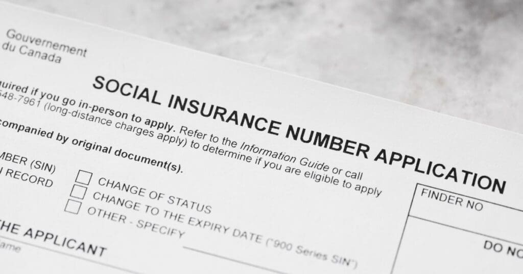 A close-up shot of the official Government of Canada Social Insurance Number Application form, highlighting sections for in-person requirements and temporary resident 900 series SIN numbers.