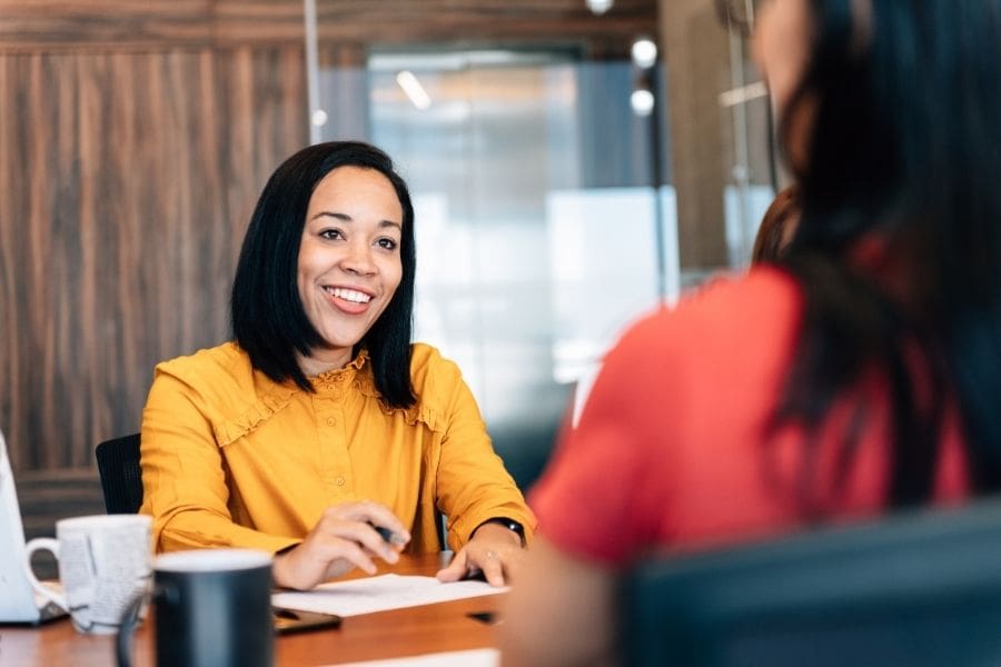 A banking representative is guiding a newcomer in their first financial meeting in Canada.