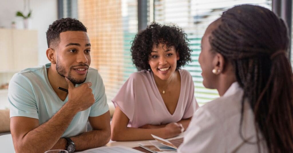 Newcomers meeting a personal banking advisor in Canada to discuss banking and budgeting.