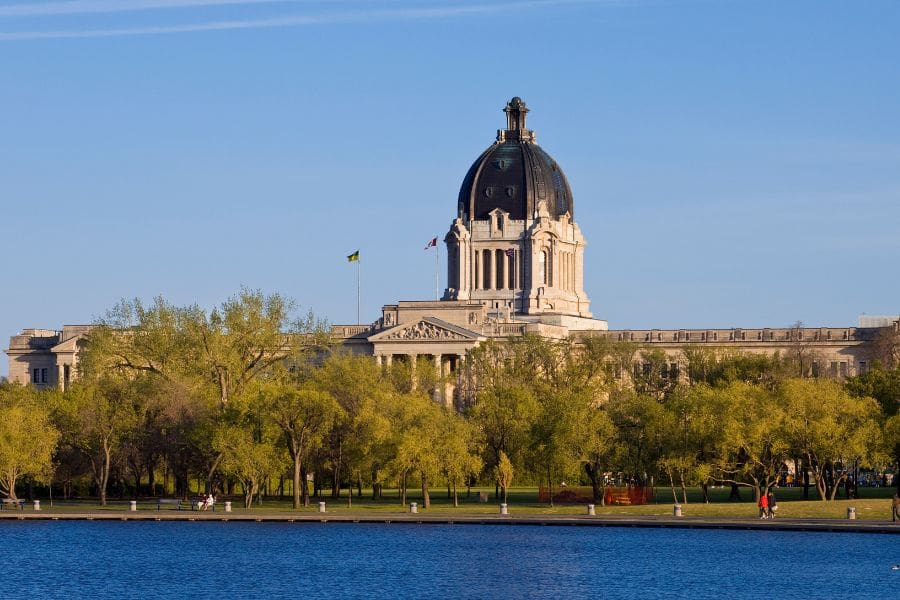 The Saskatchewan Legislative Building across Wascana Lake in Regina, an affordable capital city for Canadian immigrants.