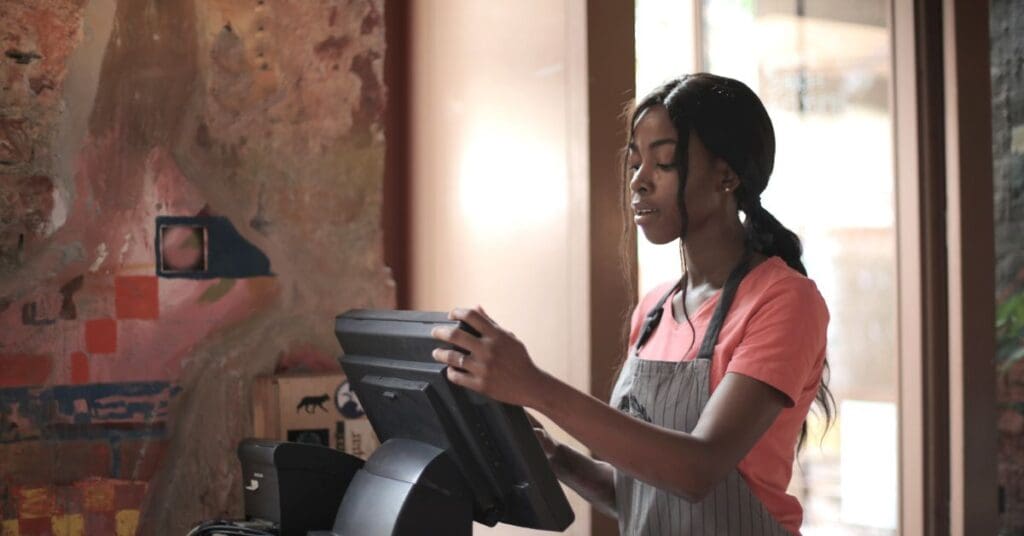 A high school teenager working a retail customer service position, representing teen summer jobs Canada options.