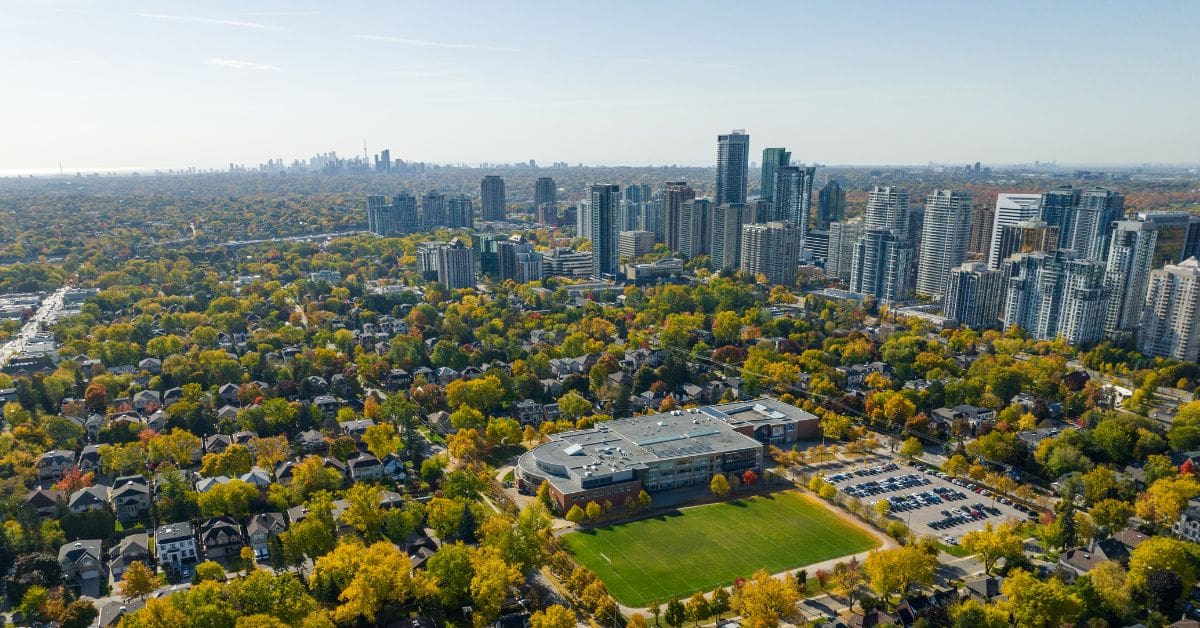 Aerial view of a North York Toronto residential neighbourhood surrounded by autumn trees and condo buildings, providing short term housing and temporary accommodation for newcomers.