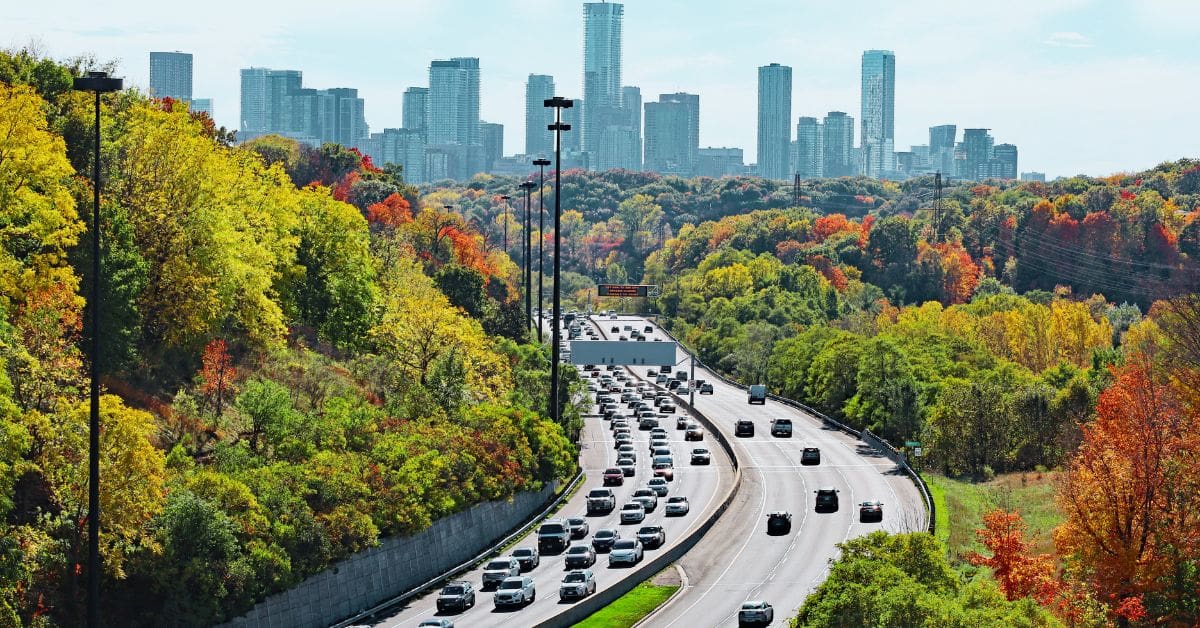 Commuter traffic on a Canadian highway, illustrating simple ways to save money on gas in Canada through fuel-efficient driving.