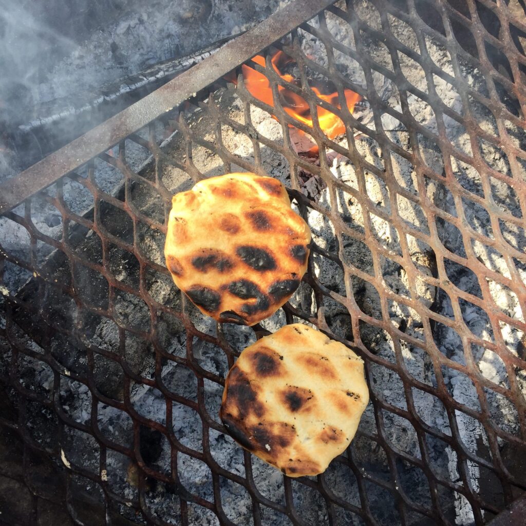 Bannock cooking on an open fire